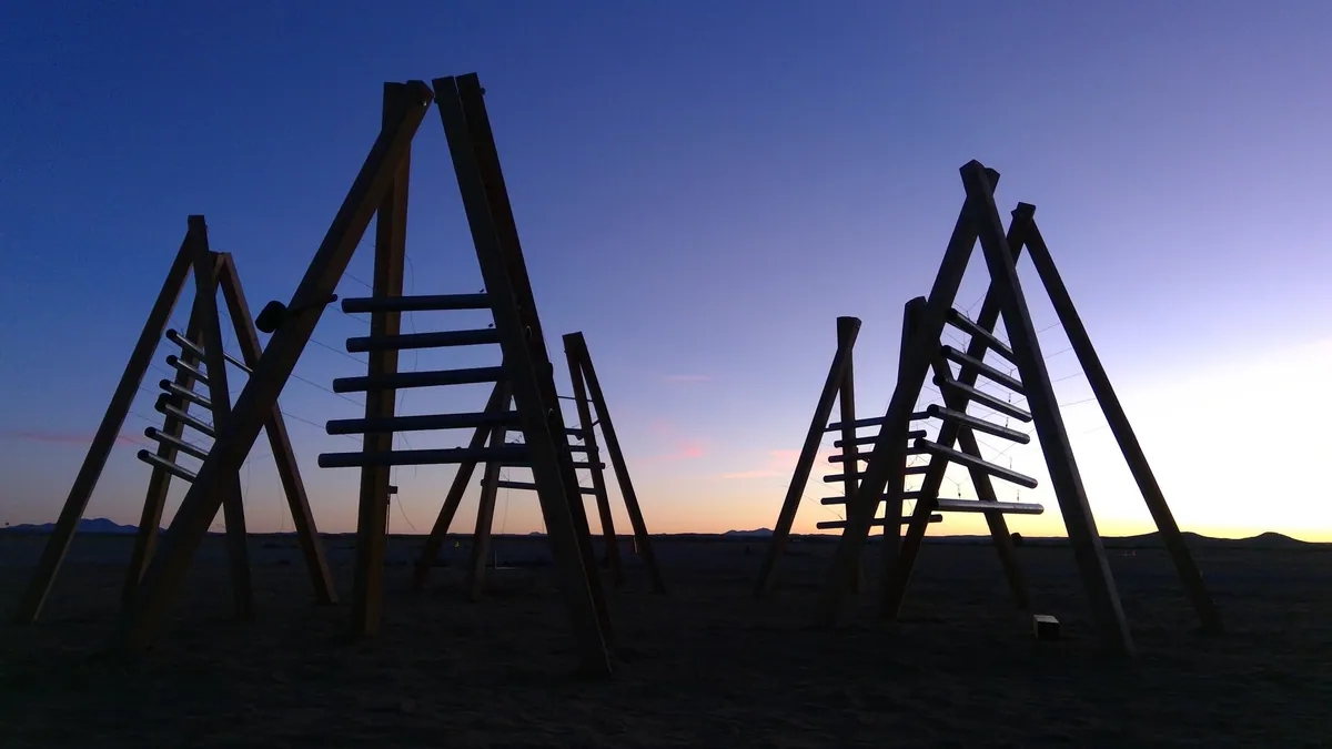 The Giant Distributed Musical Instrument silhouetted against a desert sunset