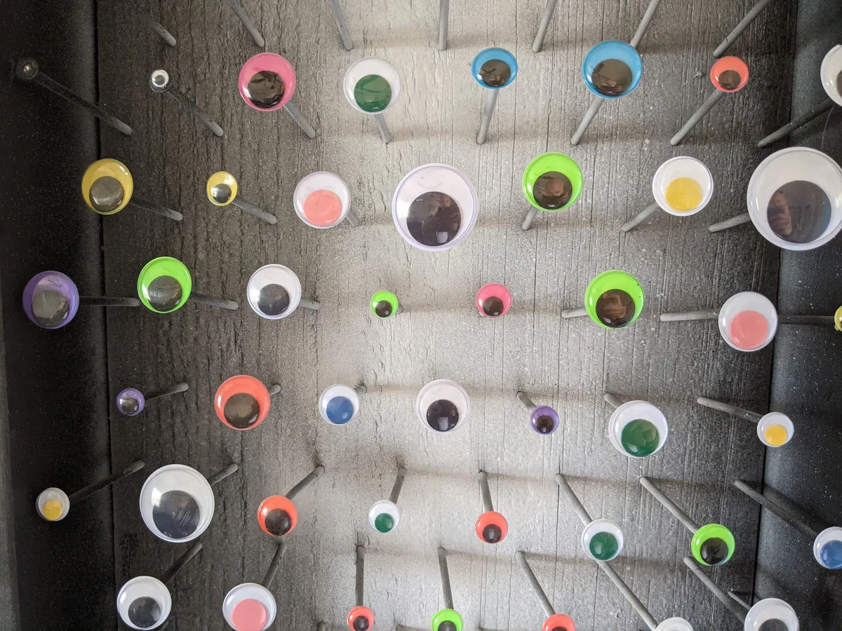 Colorful googly eyes mounted on the tuned nails of Parachinkoid